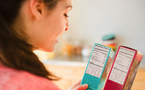 getty_rf_photo_of_woman_reading_nutrition_labels