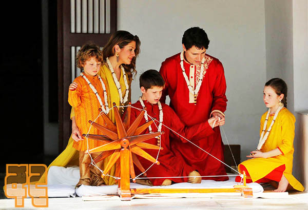 Canadian Prime Minister Justin Trudeau and his son Xavier spin cotton on a wheel watched by Trudeau's wife Sophie Gregoire Trudeau, their daughter Ella Grace and son Hadrien during their visit to Gandhi Ashram in Ahmedabad