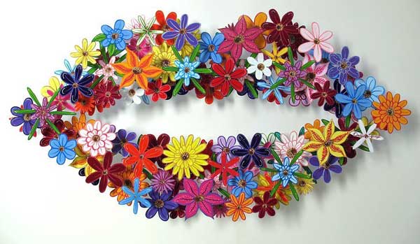 A-cute-and-colorful-metal-art-sculpture-by-artists-David-Kracov-of-a-pair-of-lips-made-out-of-flowers