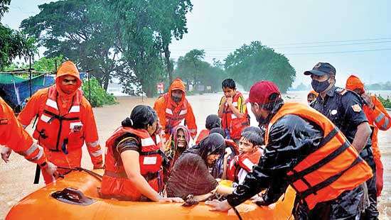 At least 112 dead in India as rains trigger floods, landslides ...