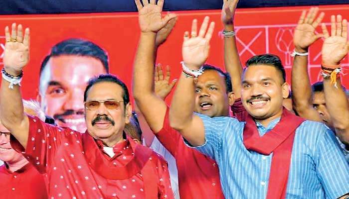 Former President and SLPP leader Mahinda Rajapaksa ,  SLPP Presidential hopeful Namal Rajapaksa, wave to the crowd during a rally in Dambulla