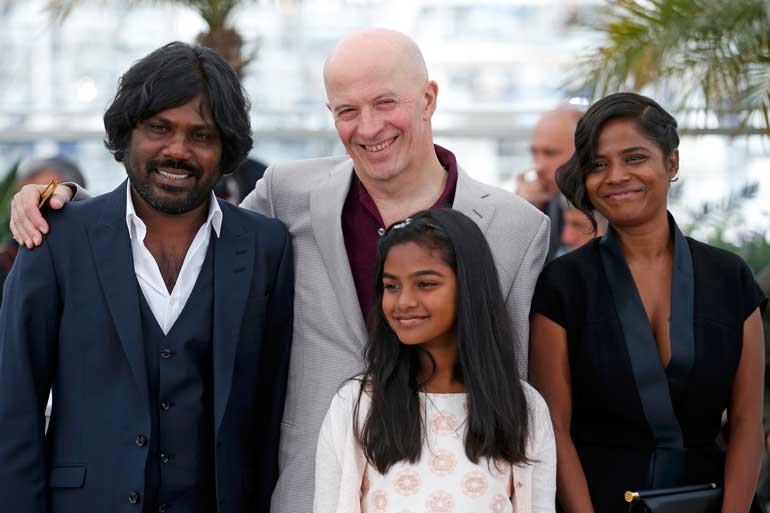 Director Jacques Audiard and cast members pose during a photocall for the film "Dheepan" in competition at the 68th Cannes Film Festival in Cannes