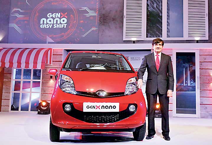 Pareek, President of Tata Motors PVBU poses with the company's new GenX Nano car during its launch in Mumbai