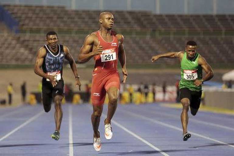Jamaica's Powell competes in the men's 100m during the national trials at the National Stadium in Kingston