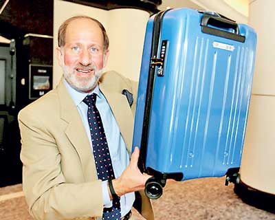 Windmuller, a vice president of the International Air Transport Association (IATA), holds a carry-on bag which conforms to a new minimum size announced by the group, at the group's annual meeting in Miami Beach