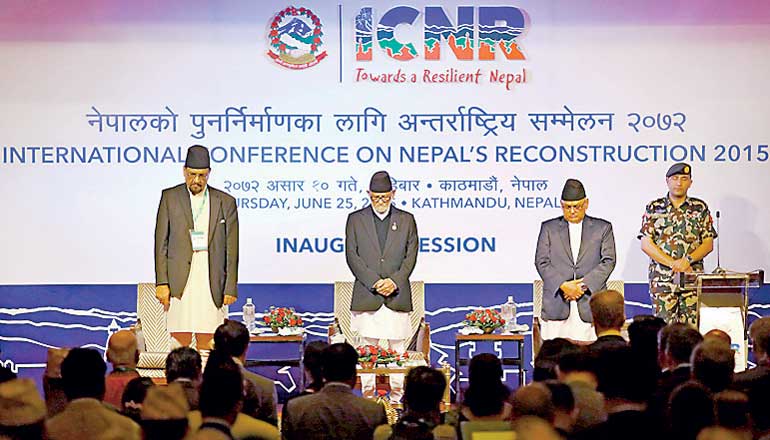 Nepal's PM Koirala along with Minister for Finance Sharan Mahat and Minister for Foreign Affairs Bahadur Panday observe one minute of silence in memory of earthquake deceases during the International Conference of Nepal Reconstruction in Kathmandu