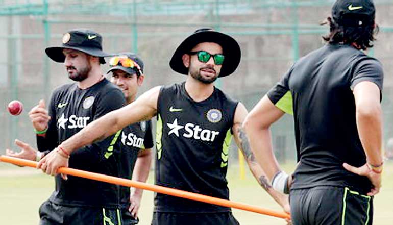 Captain of the Indian cricket team Virat Kohli and bowler Harbhajan Singh are seen during a practice session in Dhaka