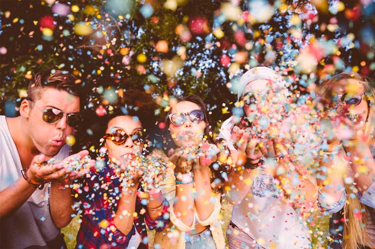 Hipsters blowing confetti