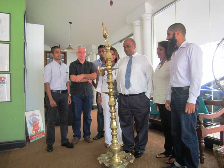 Outside-lead-1-Leo-Burnett-Solutions-Inc-Managing-Director-Ranil-de-Silva-lighing-the-oil-lamp-with-members-of-the-management-team