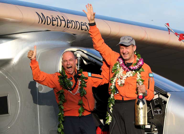 Bertrand Piccard (L) celebrates with Andre Borschberg after the Solar Impulse 2 airplane, piloted by Borschberg, landed at Kalaeloa airport after flying non-stop from Nagoya, Japan, in Kapolei, Hawaii