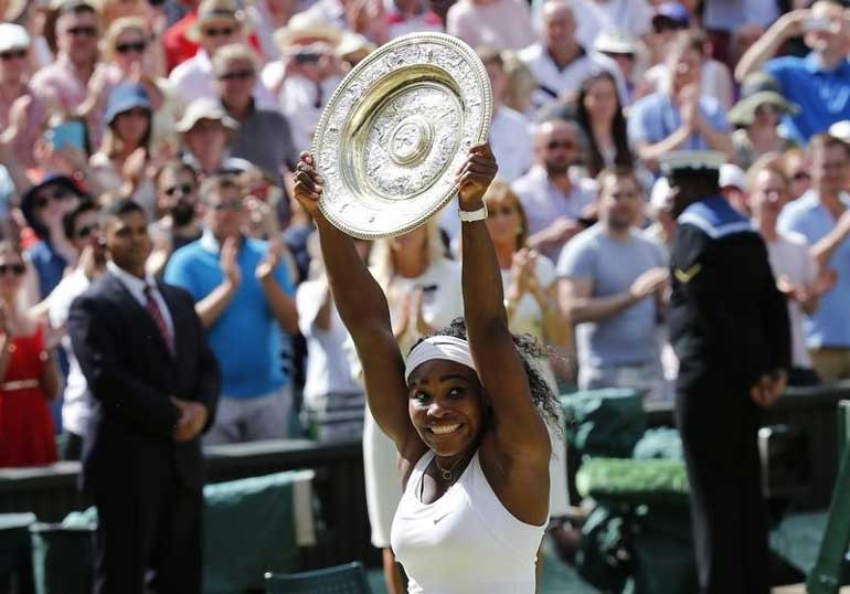 Serena Williams of the U.S.A lifts the trophy after winning her Women's Final match against Garbine Muguruza of Spain at the Wimbledon Tennis Championships in London