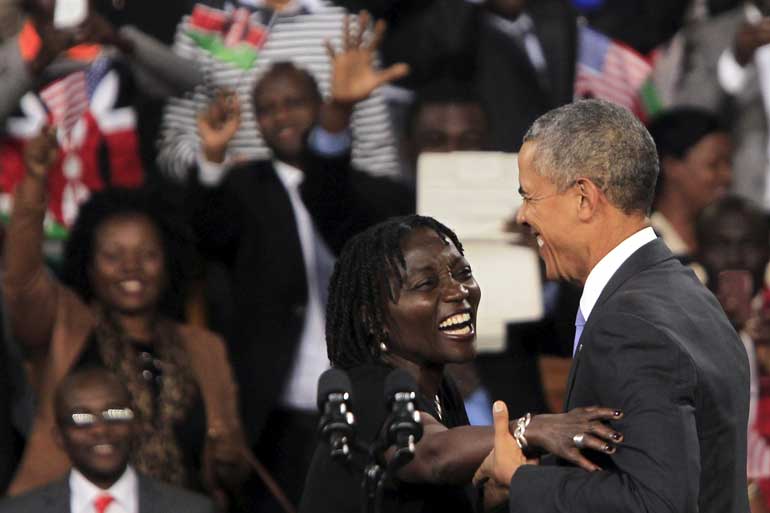 Auma Obama hugs U.S. President Barack Obama during an event at an indoor stadium in Nairobi