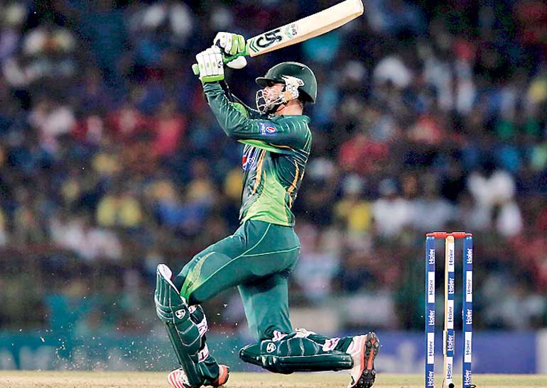 Pakistan's Malik hits boundary during their first Twenty 20 cricket match against Sri Lanka in Colombo