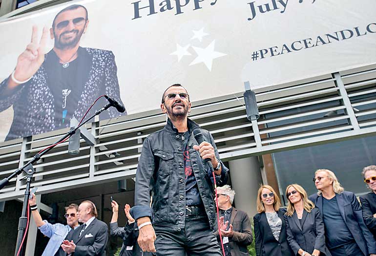 Musician Starr speaks during a "Peace & Love" event in Los Angeles