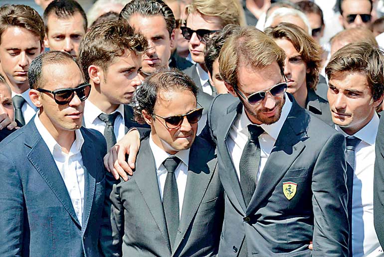 Formula One drivers Jean-Eric Vergne and Felipe Massa, friends and relatives gather gather around the coffin of late Marussia F1 driver Jules Bianchi during the funeral ceremony at the Sainte Reparate Cathedral in Nice