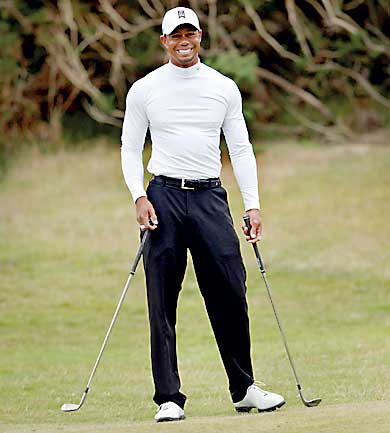 Woods of the U.S. smiles as he stands on the practice ground ahead of a practice round ahead of the British Open golf championship on the Old Course in St. Andrews, Scotland