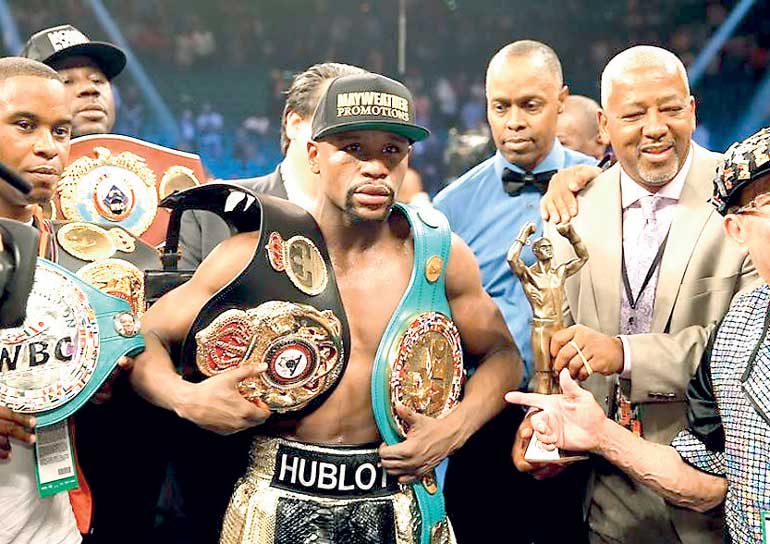 Mayweather, Jr. of the U.S. poses with his title belts after defeating Pacquiao of the Philippines in their welterweight title fight in Las Vegas