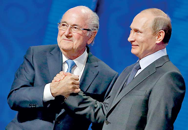 FIFA's President Blatter shakes hands with Russia's President Putin during the preliminary draw for the 2018 FIFA World Cup at Konstantin Palace in St. Petersburg