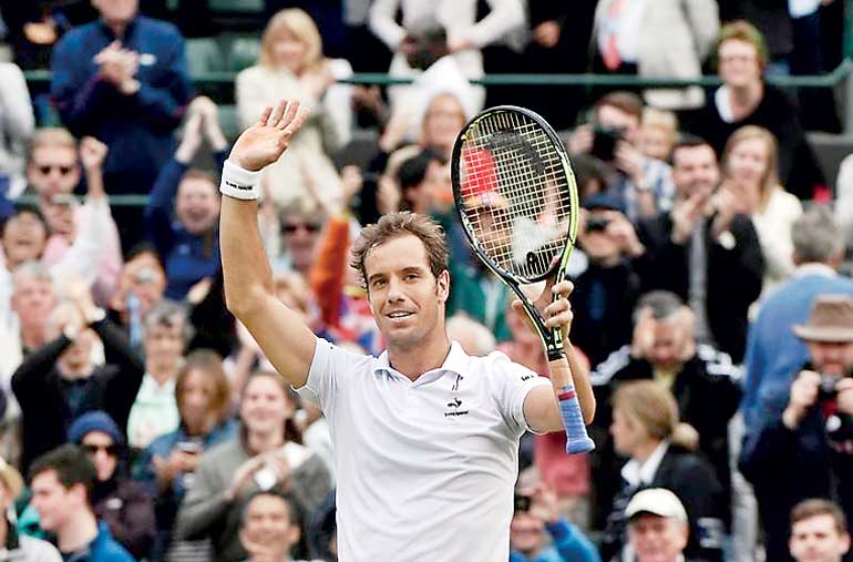 Richard Gasquet of France celebrates after winning his match against Stan Wawrinka of Switzerland at the Wimbledon Tennis Championships in London