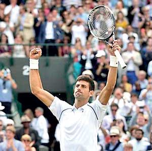 Novak Djokovic of Serbia celebrates after winning his match against Kevin Anderson of South Africa at the Wimbledon Tennis Championships in London