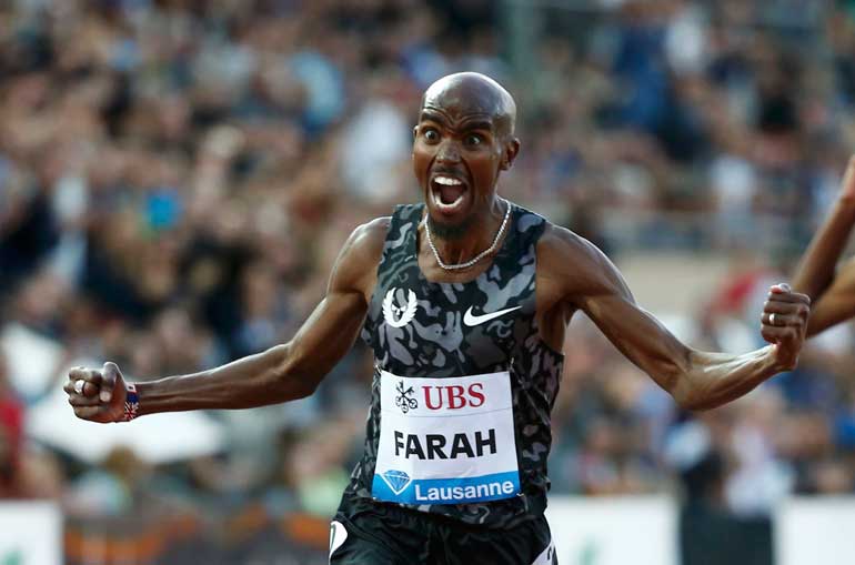 Farah of Britain finishes the 5000 metres men event at the IAAF Diamond League Athletissima athletics meeting at the Pontaise Stadium in Lausanne
