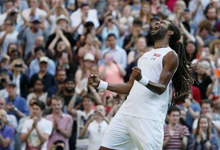 Dustin Brown of Germany celebrates after winning his match against Rafael Nadal of Spain at the Wimbledon Tennis Championships in London