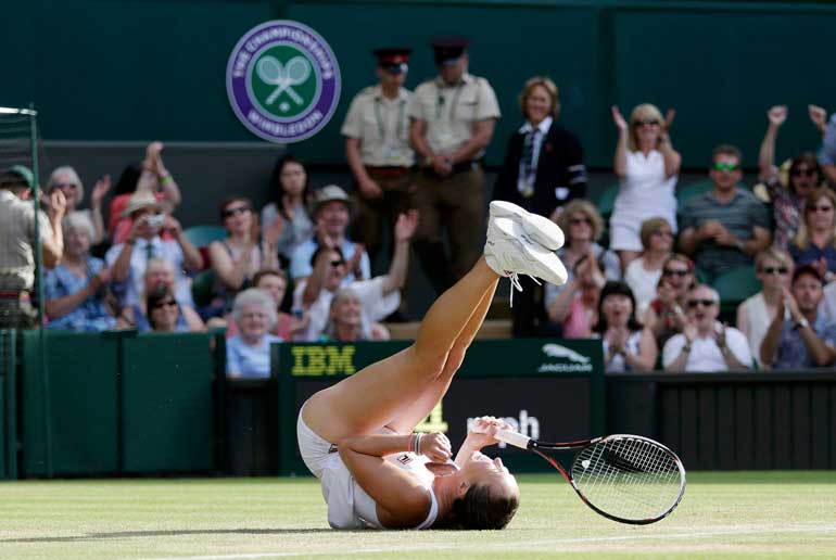 Jelena Jankovic of Serbia celebrates after winning her match against Petra Kvitova of the Czech Republic at the Wimbledon Tennis Championships in London