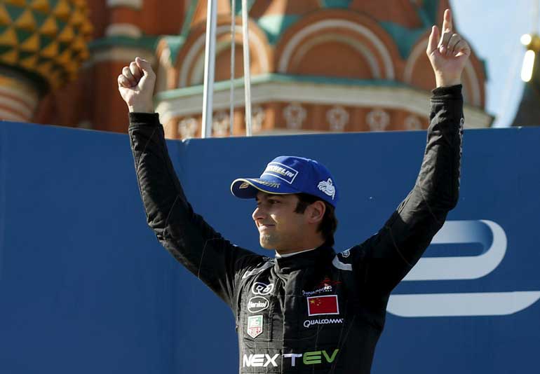 First placed NEXTEV TCR driver Nelson Piquet of Brazil celebrates on the podium after the Formula E Championship race in central Moscow