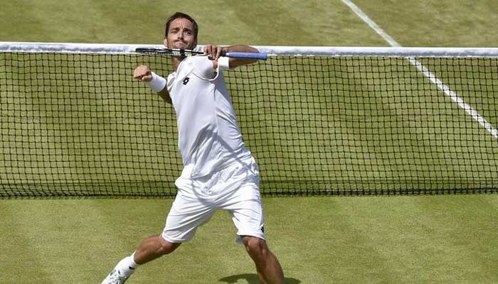 Viktor Troicki of Serbia celebrates after winning his match against Dustin Brown of Germany at the Wimbledon Tennis Championships in London