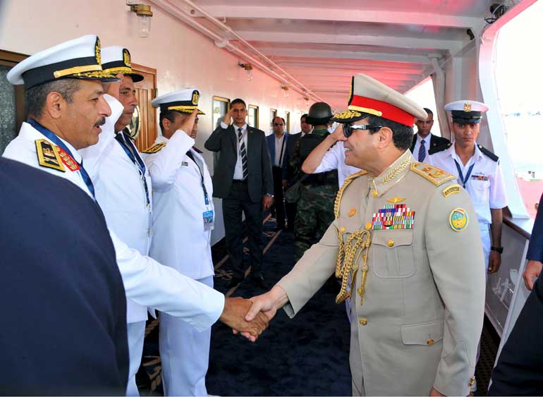 Egyptian President al-Sisi shakes hands with crew onboard historic yacht on Suez Canal during celebration of extension of Suez Canal in Ismailia