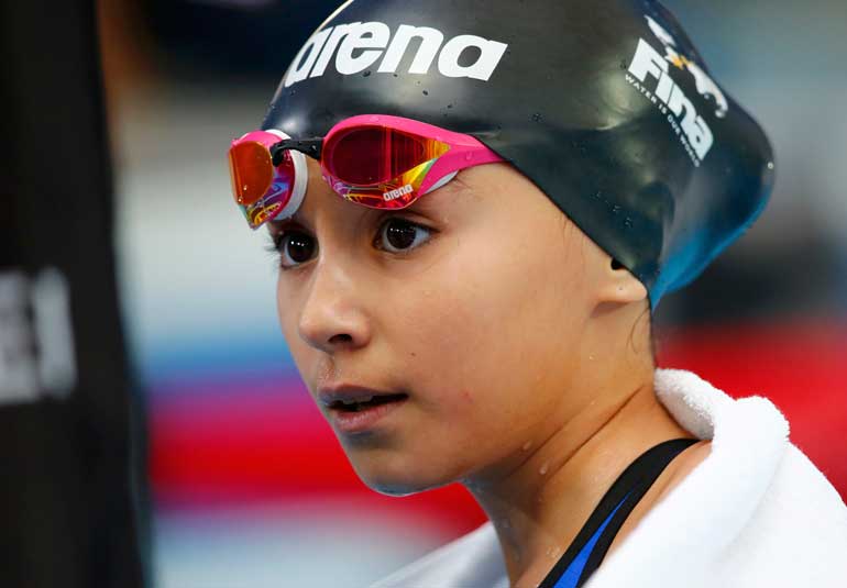 Ten year-old Alzain Tareq of Bahrain reacts after her women's 50 m butterfly at Aquatics World Championships in Kazan