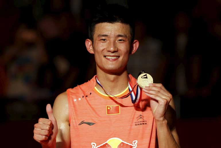 China's Chen poses with gold medal, after beating Malaysia's Lee Chong Wei during men's singles finals badminton match,  during trophy presentation at BWF World Championships in Jakarta