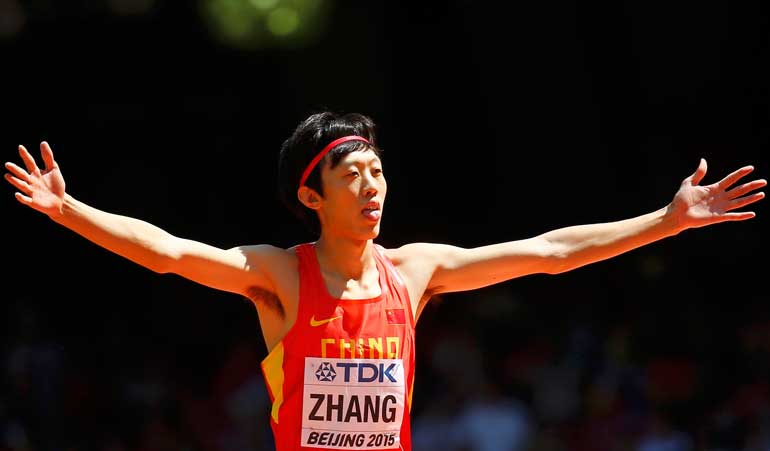 Zhang of China gestures as he competes in the men's high jump qualifying round during the 15th IAAF World Championships at the National Stadium in Beijing