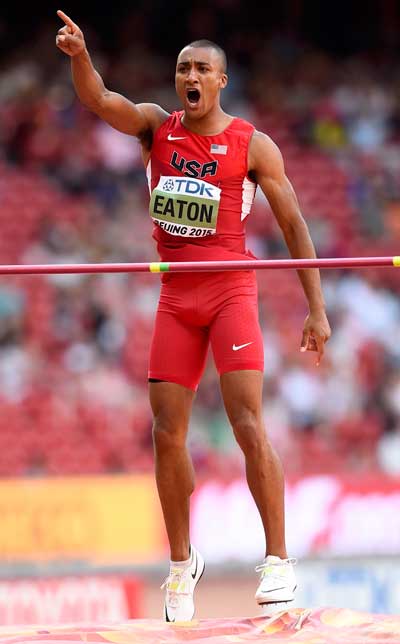 Eaton of the U.S. reacts as he competes in the high jump event of the men's decathlon during the 15th IAAF World Championships at the National Stadium in Beijing