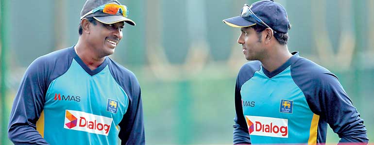 Sri Lanka's cricket captain Angelo Mathews talks with bowling coach Champaka Ramanayake during a practice session ahead of their first test cricket match against India, in Galle