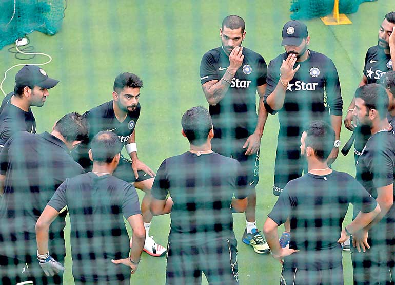 India's cricket captain Kohli stretches next to teammates during a practice session ahead of their test cricket series against Sri Lanka, in Colombo