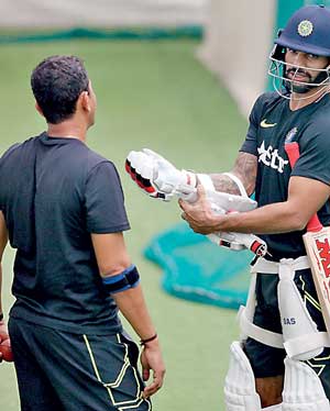 India's Dhawan talks with a coach during a practice session ahead of their test cricket series against Sri Lanka, in Colombo