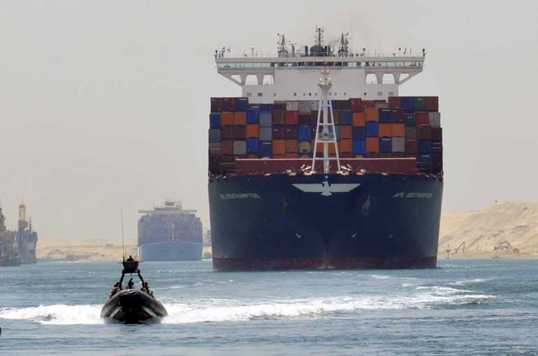 A cargo ship is seen crossing through the New Suez Canal