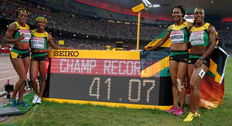 Jamaica's Elaine Thompson, Shelly-Ann Fraser-Pryce, Natasha Morrison and Veronica Campbell-Brown (L-R)  celebrate after winning the women's 4 x 100 metres relay final and setting a championship record during the 15th IAAF World Championships