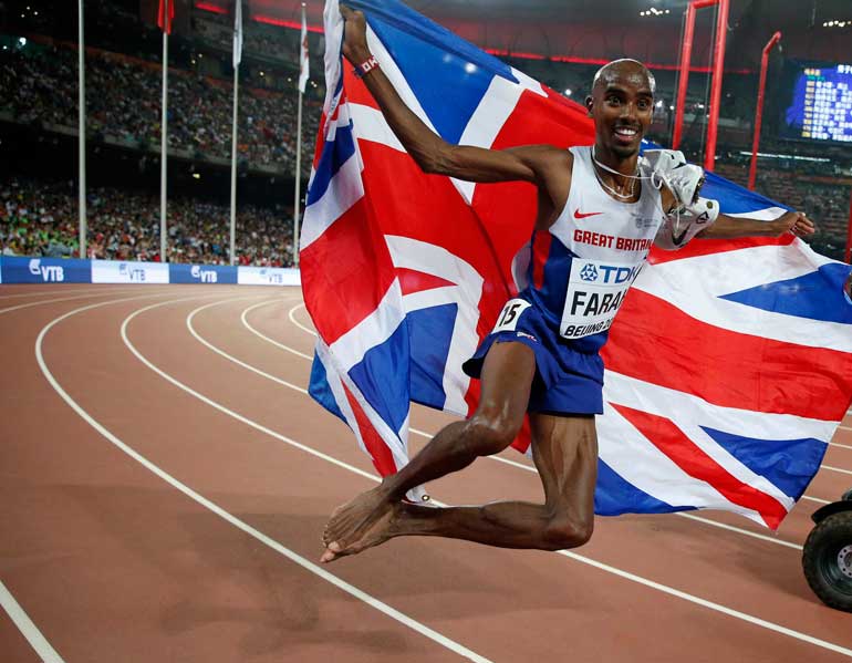 Farah holds the Union Jack flag after winning the men's 5000 metres final at the 15th IAAF Championships in Beijing