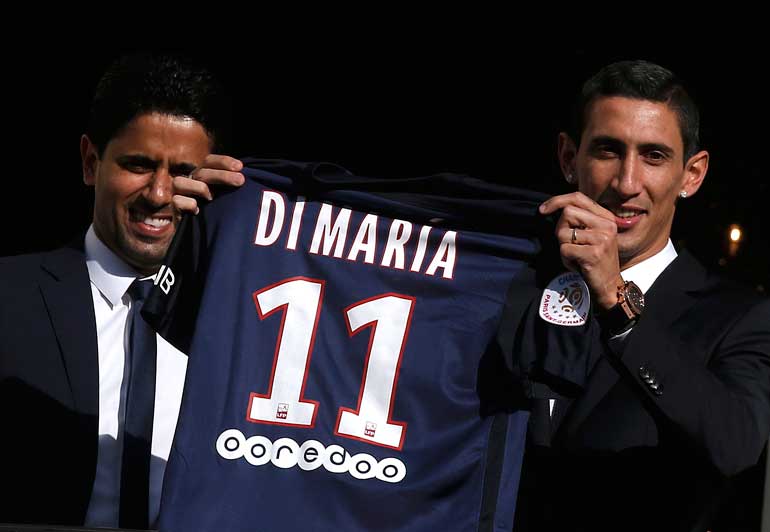 Paris Saint Germain's club president Nasser al-Khelaifi and Argentina's soccer player Angel Di Maria pose for supporters after a news conference in Paris
