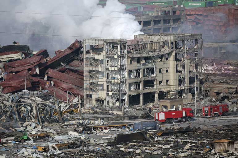 Fire engines are seen at the site of the explosions at the Binhai new district, Tianjin