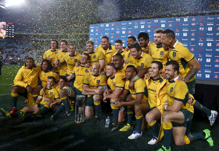 Australia's Wallabies pose with their Rugby Championship trophy after defeating New Zealand's All Blacks in Sydney