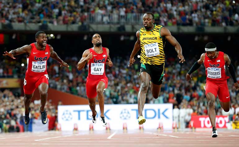 Gatlin of the U.S. and Bolt of Jamaica cross the finsih line in the men's 100 metres final during the 15th IAAF World Championships at the National Stadium in Beijing
