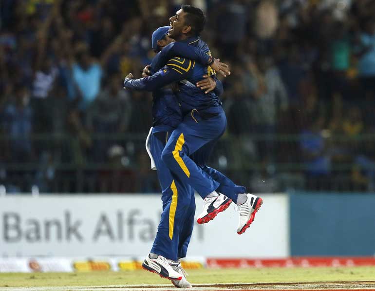 Sri Lanka's Jayasuriya celebrates with his teammate Vandersay after taking the wicket of Pakistan's captain Afridi during their second Twenty20 cricket match in Colombo