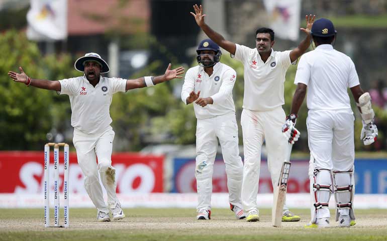 India's Ashwin, Mishra and Sharma appeal unsuccessfully for the wicket of Sri Lanka's Chandimal during the third day of their first test cricket match in Galle