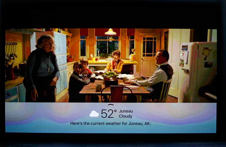 A screen shows added information via the Siri app while using Apple TV during an Apple media event in San Francisco, California