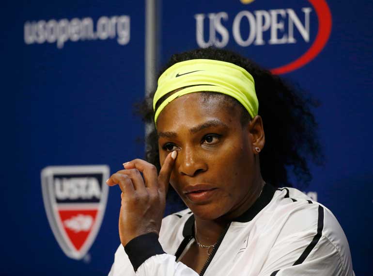 Williams of the U.S. listens to a reporter's question during a post-match press conference following her loss to Vinci of Italy in their women's singles semi-final match at the U.S. Open Championships tennis tournament in New York