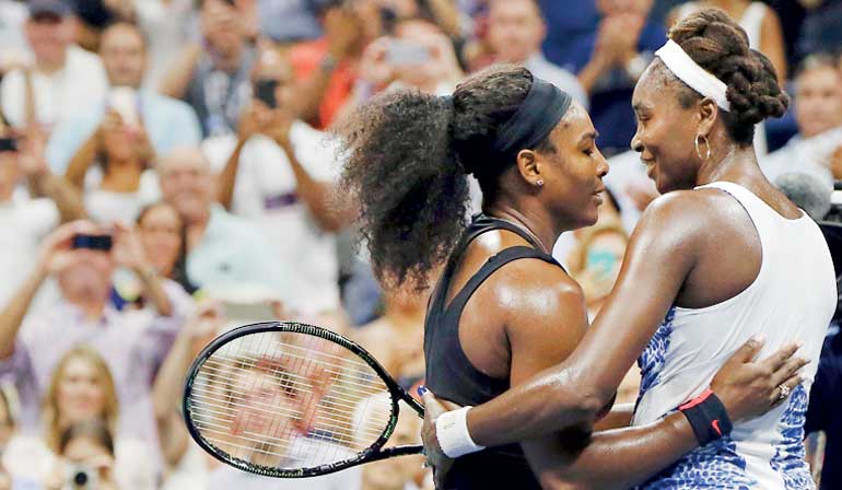 Serena Williams of the U.S. embraces her sister and compatriot Venus Williams after defeating her in their quarterfinals match at the U.S. Open Championships tennis tournament in New York