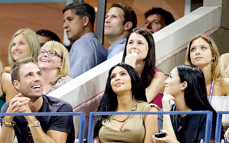 Television personality Kim Kardashian watches as Serena Williams of the U.S. plays against her sister and compatriot Venus Williams in their quarterfinals match at the U.S. Open Championships tennis tournament in New York